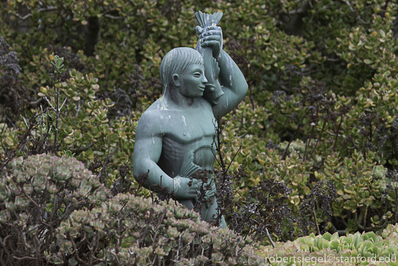 person with fish sculpture